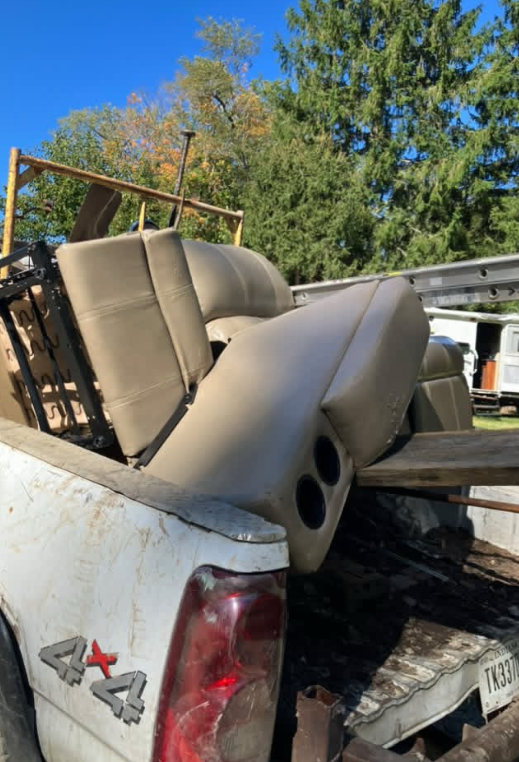 JJs Cleanup truck loaded with furniture during junk removal service in Portland, IN